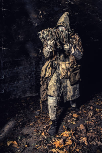 istock Post apocalyptic creature in gas mask armed gun 1203181364