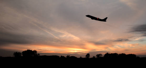 Commercial aircraft taking off the airport in evening light conditions.