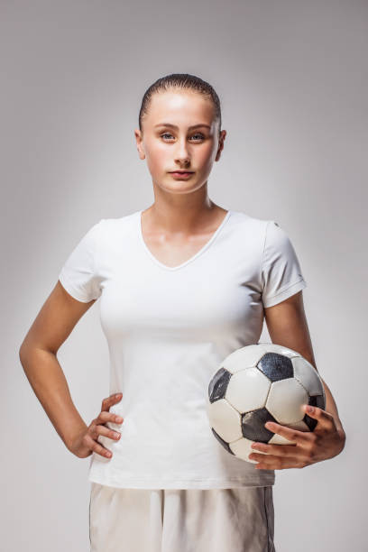 istock Beautiful Young Female Soccer Athlete in a studio shot 1203184331