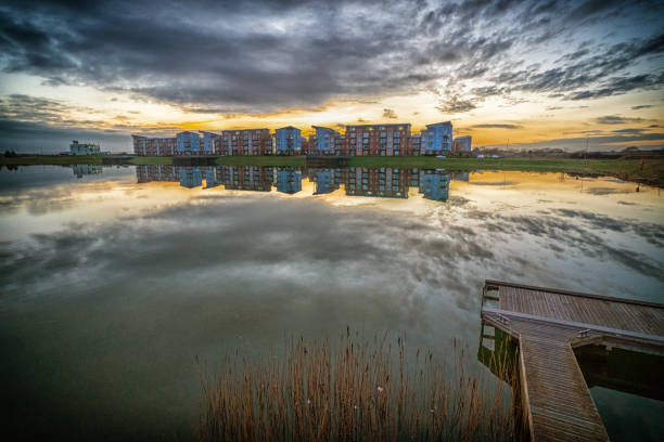 Housing apartments and reflection at sunset