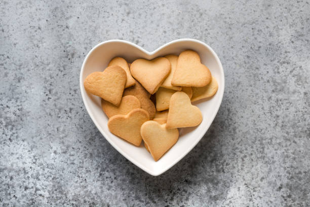 Valentines day greeting card with homemade heart shaped cookies on grey stone table. Top view.