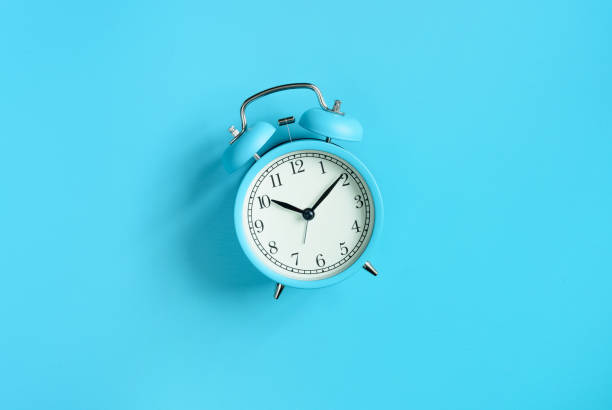 istock Blue vintage alarm clock on blue background. Top view. Flat lay 1203185067