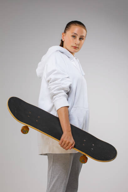 istock Beautiful Young Female Skateboard Athlete in a studio shot 1203185166