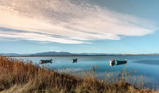 Photo of Fishing boats on the Pond of Canet Saint Nazaire and the mount Canigou in Canet en Roussillon