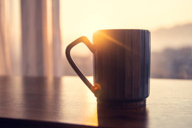 istock Coffee cup on table in the morning 1203186387