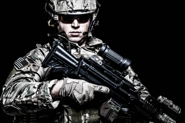 istock US army soldier with rifle on black background 1203186786