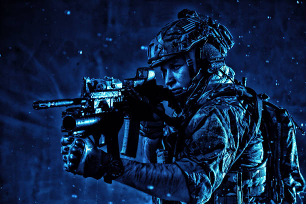 istock Soldier aiming service rifle under rain at night 1203186841