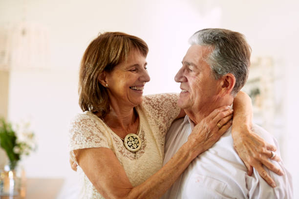 istock A senior wife embraces her husband affectionately. 1203187638