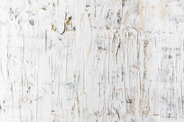 istock Rough white painted on newspaper wall. Perfect for background. Abstract  texture. White wallpaper. 1203187817