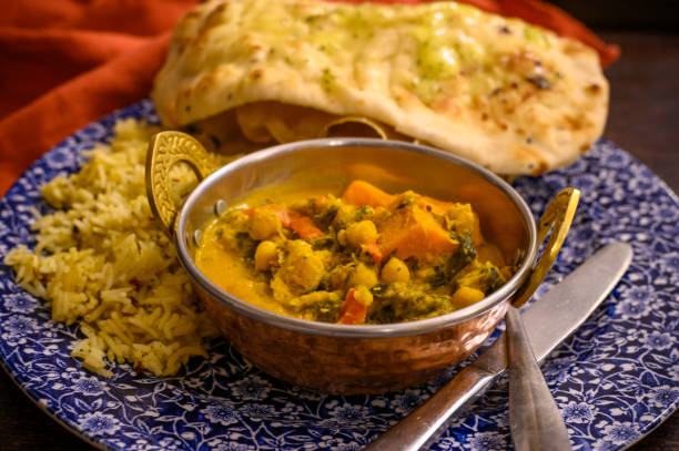 istock Mangalorean style roasted cauliflower and spinach curry with basmati rice and garlic naan bread, tasty vegetarian food 1203189302