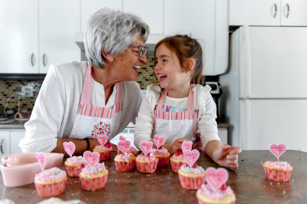 Grandmother and grandchild cooking stock photo