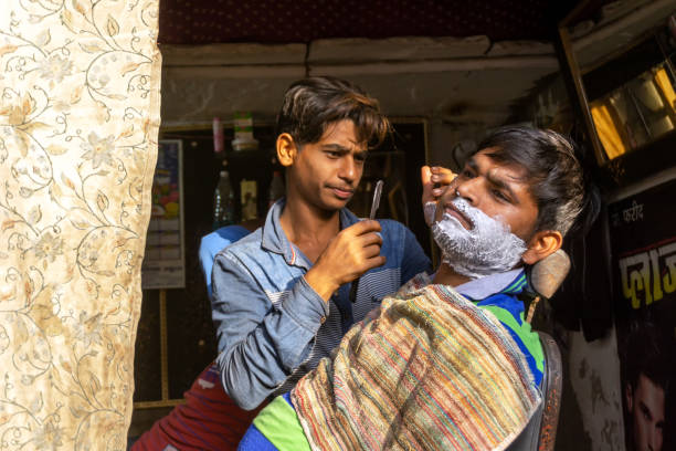 New Delhi, India - March 03, 2018: Unidentified man shaving a beard at Barber shop.