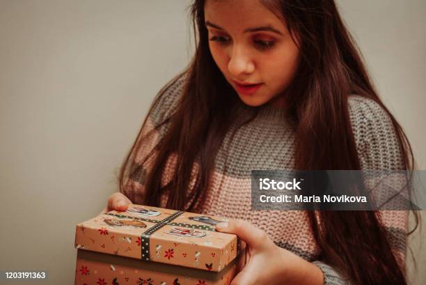Teenage Girl Holding Christmas Gift Stock Photo - Download Image Now - Beautiful People, Box - Container, Celebration