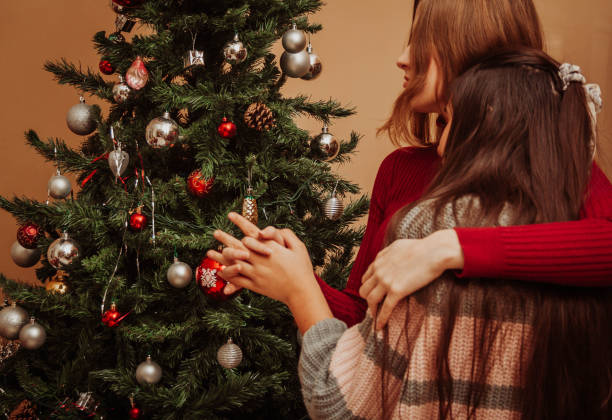 istock Two girls decorating the Christmas tree 1203191746