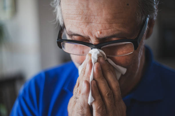 senior man have allergy and blowing nose with tissue - allergy sneezing cold and flu flu virus imagens e fotografias de stock