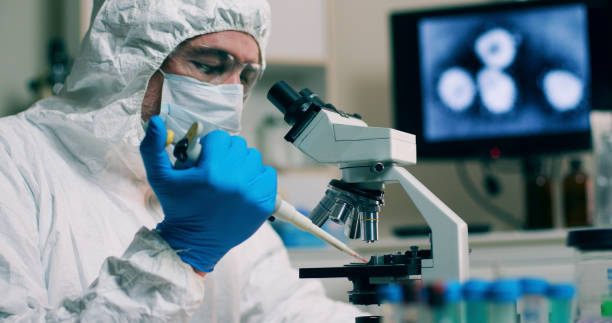 istock A research scientist working in his laboratory with a sample or specimen and an image of the Wuhan Coronavirus displayed on a computer screen. 1203192083