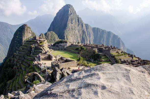 istock Macchu Picchu unveiling behind a stone 1203192098