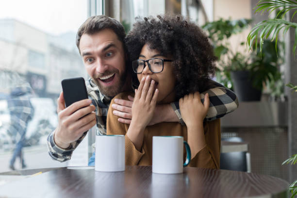 istock Smiling young couple making selfie in coffee shop 1203193533