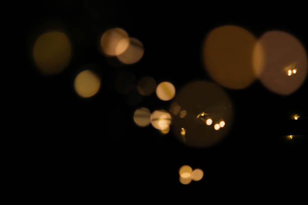 istock Bright defocused, golden and yellow lights on black background 1203193625