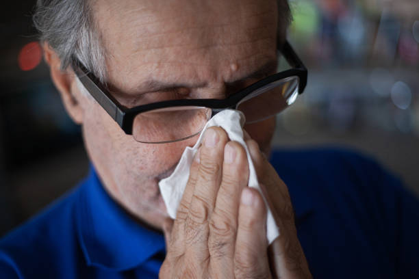 istock Senior man have allergy and blowing nose with tissue 1203194549