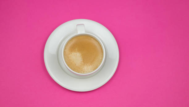 istock Creative flat lay overhead top view coffee milk latte cup on millennial pink background copy space minimal style. feminine blog social media 1203194728