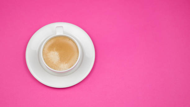 istock Creative flat lay overhead top view coffee milk latte cup on millennial pink background copy space minimal style. feminine blog social media 1203194773