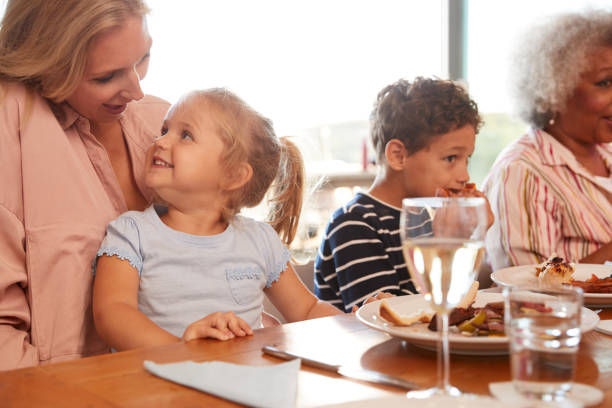 istock Multi-Generation Family Sitting Around Table Enjoying Meal At Home Together 1203194799