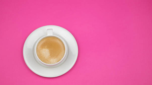 istock A cup of black coffee on pink background. View from above. copy space 1203194888