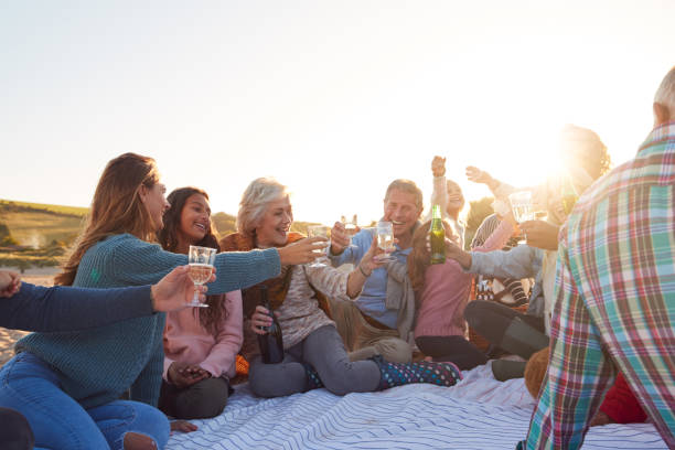 istock Multi-Generation Family Making A Toast With Alcohol On Winter Beach Vacation 1203196139