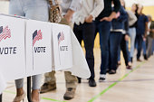 Low angle view of people lined up to vote