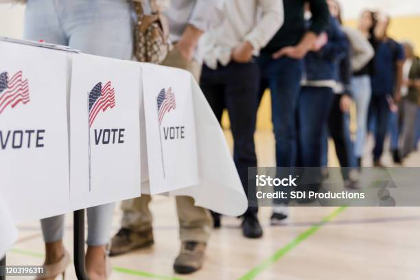 Low Angle View Of People Lined Up To Vote Stock Photo - Download Image Now - Voting, Election, USA