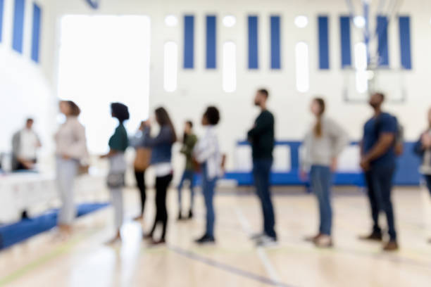 istock Defocused photo multi-ethnic group lined upto vote 1203196337