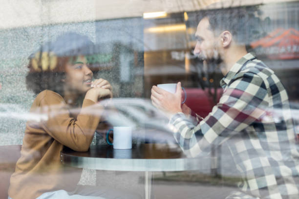 istock Happy young man and woman nice chatting in a cafe 1203199005