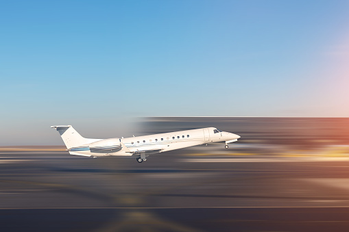 Mid size modern vip private jet departure and take-off on airport runway. Pilot asking air traffic control officer for take-off clearance. Luxury small corporate charter business aircraft trip .