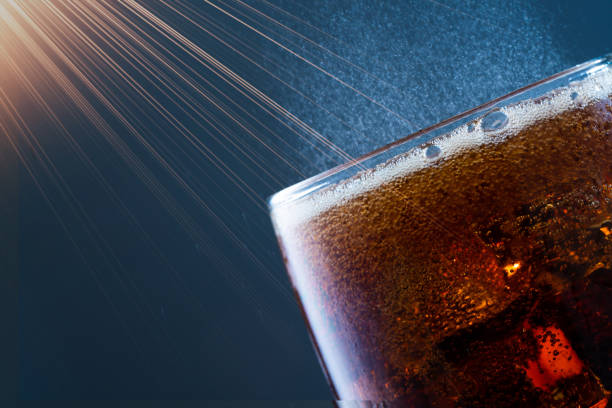Beautiful glass for whiskey on a red background close-up.