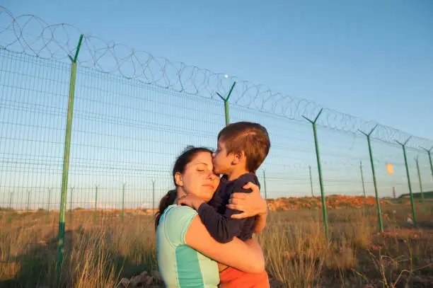 Photo of release of prisoners on state border happy child kissing mother after refugee family reunion