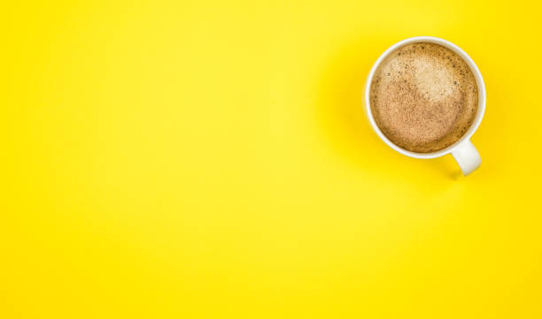 istock A cup of black coffee on yellow background. View from above. copy space 1203205195
