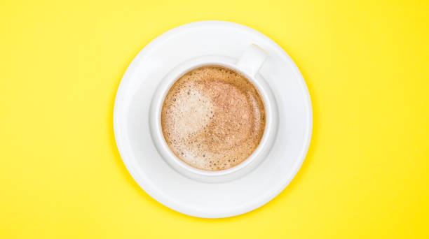 istock A cup of black coffee on yellow background. View from above. copy space 1203205999