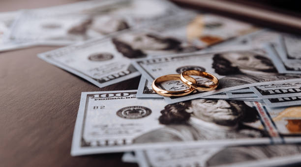 Wedding rings on money background