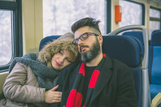 istock Couple sleeping in train woman man vacation romantic passengers 1203206766