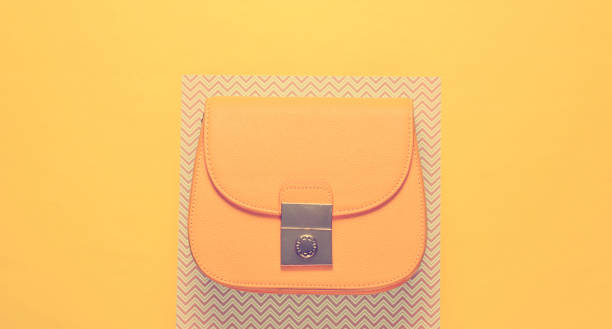 istock Women's yellow leather bag on a creative background, minimalism 1203209332