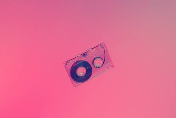 istock Minimalism retro style concept. 80s. Audio cassette in neon red blue light. Retro wave 1203209757