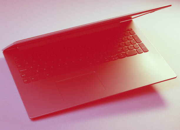 istock Modern laptop with vibrant color lights. Minimal office surrealism concept. 1203211256