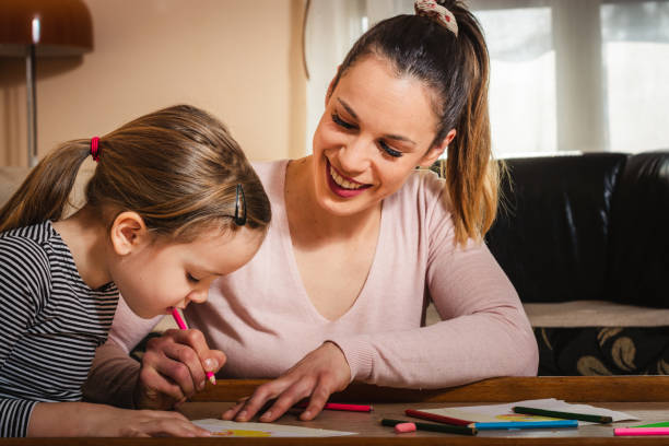 istock Mother and daughter drawing. 1203212647