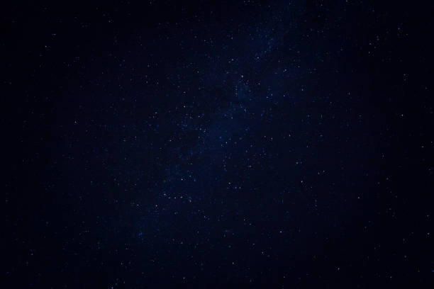 istock Milky way and stars in black sky background. 1203212842