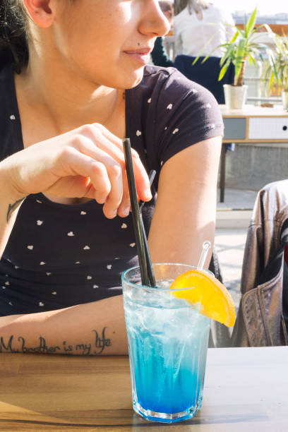 istock Blue lady cocktail on brown wood table 1203213608