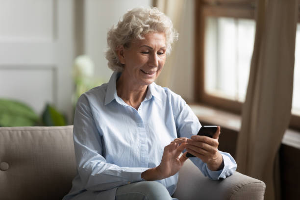 istock Happy middle aged lady making purchases in online store. 1203214369