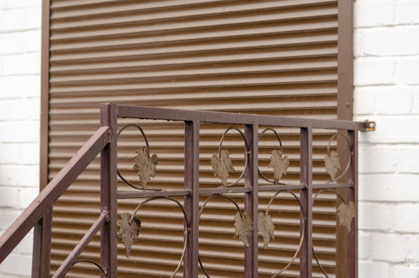 istock Door in a white brick wall with anti-vandal protection. 1203214378