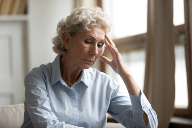 istock Stressed mature elderly grandmother feeling unwell, sitting alone at home. 1203214391