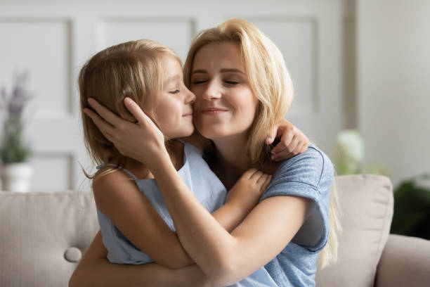 istock Affectionate young mother embracing small daughter. 1203214427